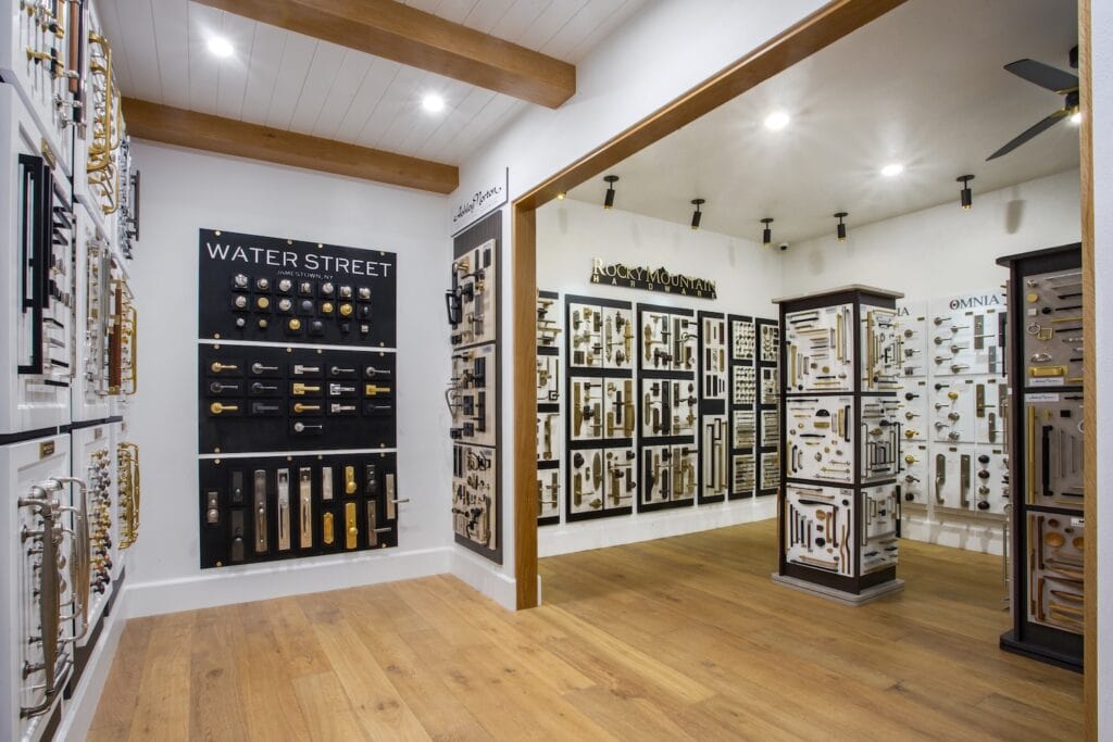 Interior view of the First White Room looking into Second White Room at CDM Hardware in Costa Mesa, featuring Water Street Brass, Ashley Norton, Rocky Mountain Hardware, Emtek, Omnia Industries.